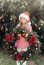 Merry Christmas. Portrait of happy funny child girls in Santa hat with Christmas wreath Royalty Free Stock Photo