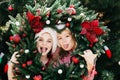 Merry Christmas. Portrait of two happy funny children girls in Santa hat with Christmas wreath Royalty Free Stock Photo