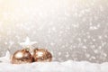 Merry Christmas postcard. Balls and stars baubles on snow and defocused snowfall Royalty Free Stock Photo