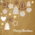 Merry Christmas postcard with gingerbread & cookies on a crumpled paper brown background.