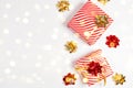 Happy New Year horizontal composition with gifts box, golden and red bow, glitter light on white background with copy space. Flat Royalty Free Stock Photo