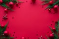 Merry Christmas red background decorated with new year tree baubles flat lay Royalty Free Stock Photo