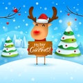 Merry Christmas! The red-nosed reindeer holds wooden board sign in Christmas snow scene winter landscape Royalty Free Stock Photo