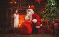 Merry Christmas! santa claus and child girl at night at the Chr Royalty Free Stock Photo