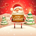 Merry Christmas! Santa Claus holds wooden board sign in Christmas snow scene winter landscape Royalty Free Stock Photo