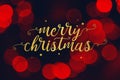 Merry Christmas Script and Stars with Red Bokeh Lights Background Royalty Free Stock Photo