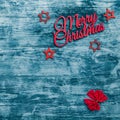 Merry Christmas sign and handmade fir toys, with red ribbon in corners, blue wooden background, Xmas greeting card Royalty Free Stock Photo