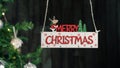 Merry Christmas Sign Hanging With Tree On The Background