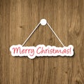 Merry Christmas sign hanging on a wood plank Royalty Free Stock Photo