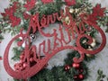 Merry Christmas sign, over evergreen wreath Royalty Free Stock Photo