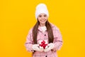 merry christmas. smiling cute kid in winter hat with box. teen girl in mittens