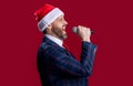 merry christmas. smiling event host man singing at christmas isolated on red. christmas event host