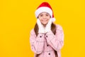 merry christmas. smiling kid in santa claus hat. teen girl in mittens on yellow background.