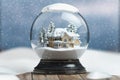 Merry christmas snow globe with a house on snowfall winter background Royalty Free Stock Photo