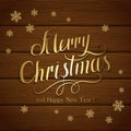 Merry Christmas with snowflakes on brown wooden background Royalty Free Stock Photo