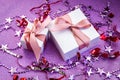 Merry Christmas or St Valentines Day card made of decorations, white gift boxes with pink ribbon, sparkles and confetti Royalty Free Stock Photo