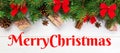 Merry Christmas text. Christmas background with fir tree and gift box on wooden table. Top view with banner copy space Royalty Free Stock Photo