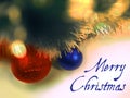 Merry Christmas text in blue color on christmas tree ball toys and garlands background. Royalty Free Stock Photo