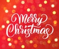 Merry Christmas text. Holiday greetings quote. Golden sparkling glowing lights. Red background with bokeh effect. Royalty Free Stock Photo