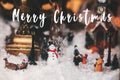 Merry Christmas text on Little Christmas city in miniature with Royalty Free Stock Photo