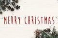 Merry Christmas text on modern christmas flat lay with green fir Royalty Free Stock Photo