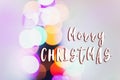 Merry christmas text sign on colorful lights. bright bokeh. magi