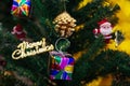 Merry Christmas text sign ornament attached on Xmas tree - selective focus Royalty Free Stock Photo
