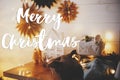 Merry Christmas text on stylish eco friendly christmas gifts, little house, trees, stars and christmas golden lights bokeh. Season Royalty Free Stock Photo