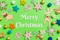 Merry Christmas text. Top view of green background with New Year toys and decorations. Christmas time concept with copy Royalty Free Stock Photo