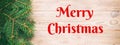 Merry Christmas text. Christmas vintage, toned banner orange wooden background with fir tree and copy space. top view Royalty Free Stock Photo