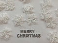 Merry christmas text on white background covered with snowflakes. Christmas concept. Silver letters. copy space Royalty Free Stock Photo