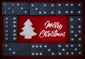 Merry Christmas text in white color and christmas tree and domino background.
