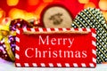 Merry Christmas text wooden sign, decorations and ornaments in a colorful Christmas composition Royalty Free Stock Photo