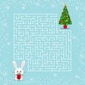 Merry Christmas theme maze game for the children with a labyrinth. Cartoon bunny with gift and christmas tree Royalty Free Stock Photo