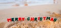 Merry Christmas to the inscription with a Christmas tree. The beginning of a new year in a journey by the sea. Celebrating Royalty Free Stock Photo