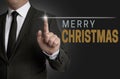 Merry Christmas touchscreen operated by businessman concept