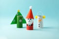 Merry christmas toy collection santa claus, snowman, tree on blue for Winter holiday concept background. Paper crafts, DIY.