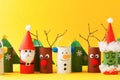 Merry christmas toy collection santa claus, snowman, tree, reindeer on yellow for Winter holiday concept background. Paper crafts Royalty Free Stock Photo