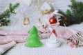 Merry Christmas, toy house, New Year decorations, illumination, spruce branches on the background of a knitted plaid Royalty Free Stock Photo