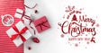 Merry Christmas Typographical on white and red paper background with gift boxes, red decoration Royalty Free Stock Photo