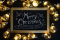 Merry Christmas Typography on Blackboard Between Light Bulbs on Royalty Free Stock Photo