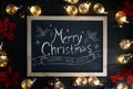 Merry Christmas Typography on Blackboard Between Light Bulbs and Royalty Free Stock Photo