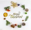 MERRY CHRISTMAS TYPOGRAPHY. FIR BRANCH AND CHRISTMAS DECOR ORNAMENT IN CIRCLE