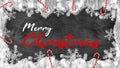 Merry Christmas / winter background template - Frame made of snow with snowflakes bokeh lights, candy canes and ice crystals on Royalty Free Stock Photo