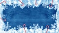 Merry Christmas / winter background template - Frame made of snow with snowflakes bokeh lights, candy canes and ice crystals on Royalty Free Stock Photo