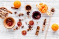 Merry christmas in winter evening with warm drink. Hot mulled wine or grog with fruits and spices on light background Royalty Free Stock Photo