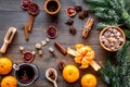 Merry christmas in winter evening with warm drink. Hot mulled wine or grog with fruits and spices on wooden background Royalty Free Stock Photo