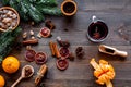 Merry christmas in winter evening with warm drink. Hot mulled wine or grog with fruits and spices on wooden background Royalty Free Stock Photo