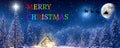 Merry Christmas - A winter wonderland Christmas scene, with a log cabin, Santa\'s slay, north star and reindeer silhouette Royalty Free Stock Photo