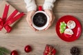 Merry Christmas with woman hand holding coffee cup and homemade cookie on table. Xmas eve, party, holiday and happy New Year Royalty Free Stock Photo